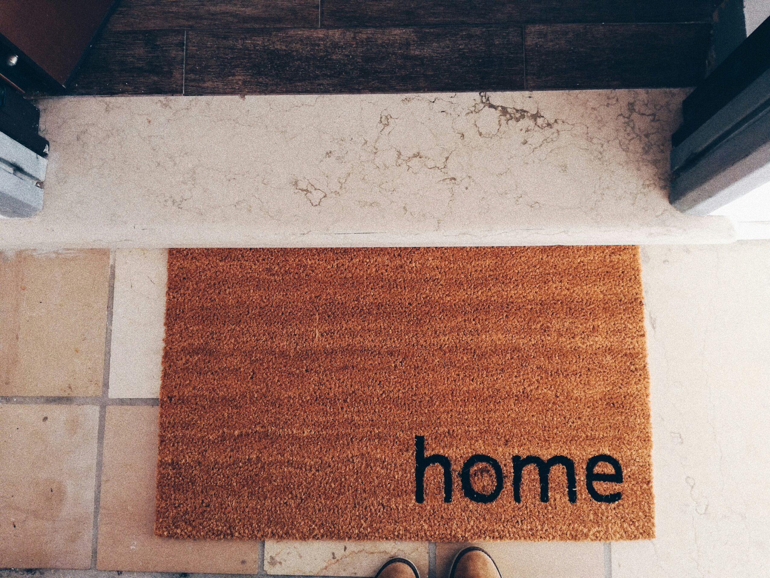 A person visiting the front door of a home.