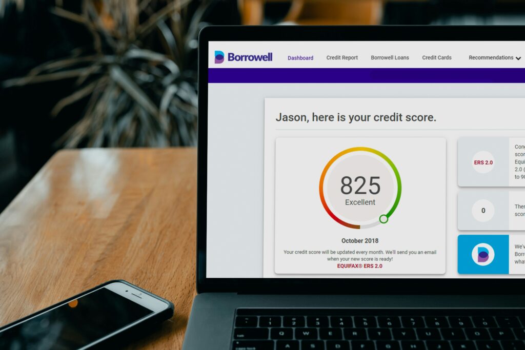 A laptop with a credit score displayed on the screen.