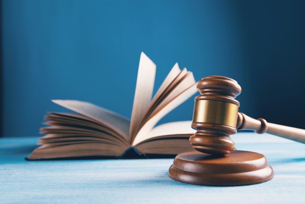 A gavel rests next to an open book.