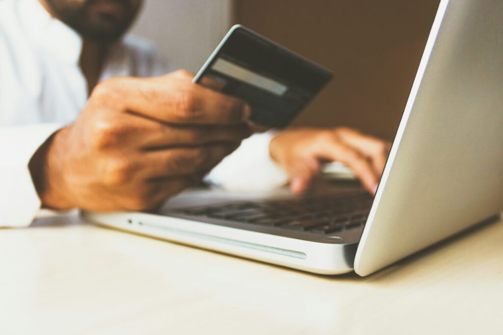 A person makes an online payment using their debit card.