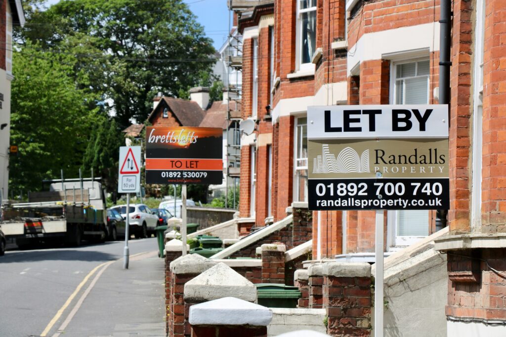 A row of properties with To Let signs outside.