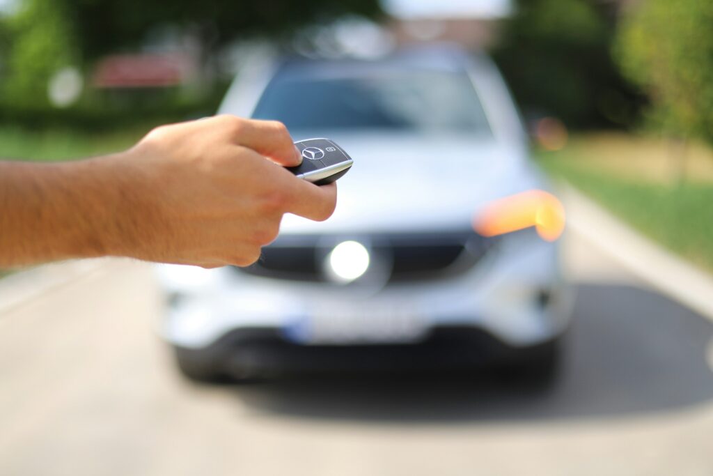 A person uses remote central locking to open a car.