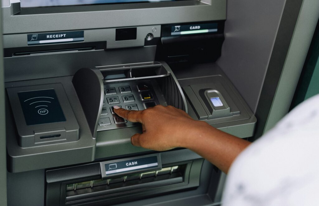 A person using a cash machine (ATM).