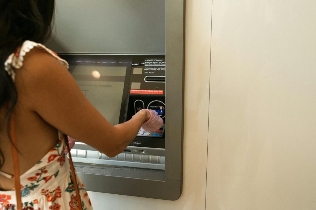 A person uses a cash machine.