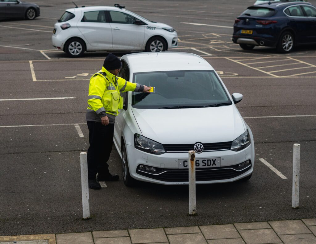 A car receives a parking ticket.