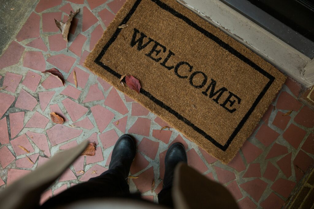 Someone stands at an open door.