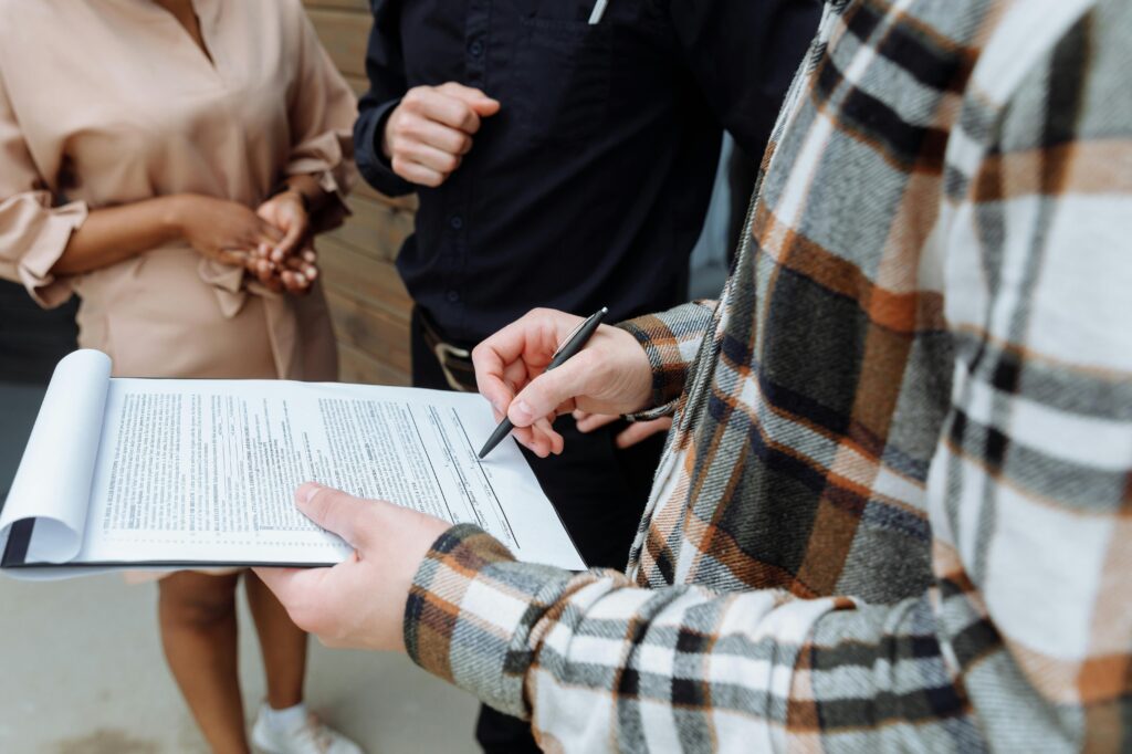 A person signs a contract.