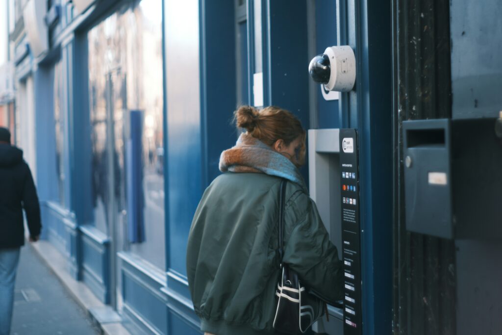 A woman uses a cash machine.
