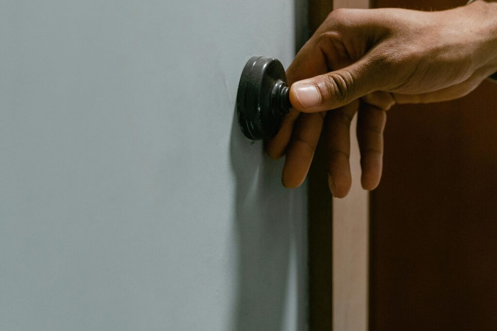 A person rings a doorbell.